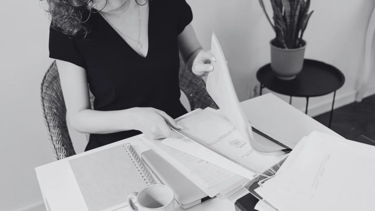 What-Is-a-Business-Process-Documentation-Template-and-How-to-Use-It-1280×720 professional reviewing business documents for virtual professional services